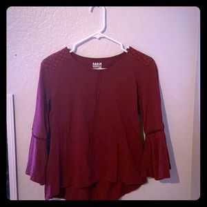 This is a burgundy shirt with flared sleeves